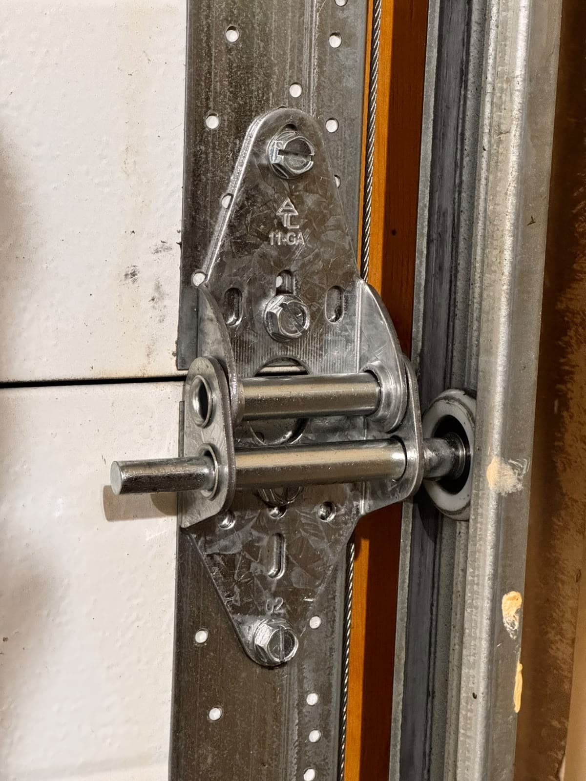New garage door hinge installed after repair